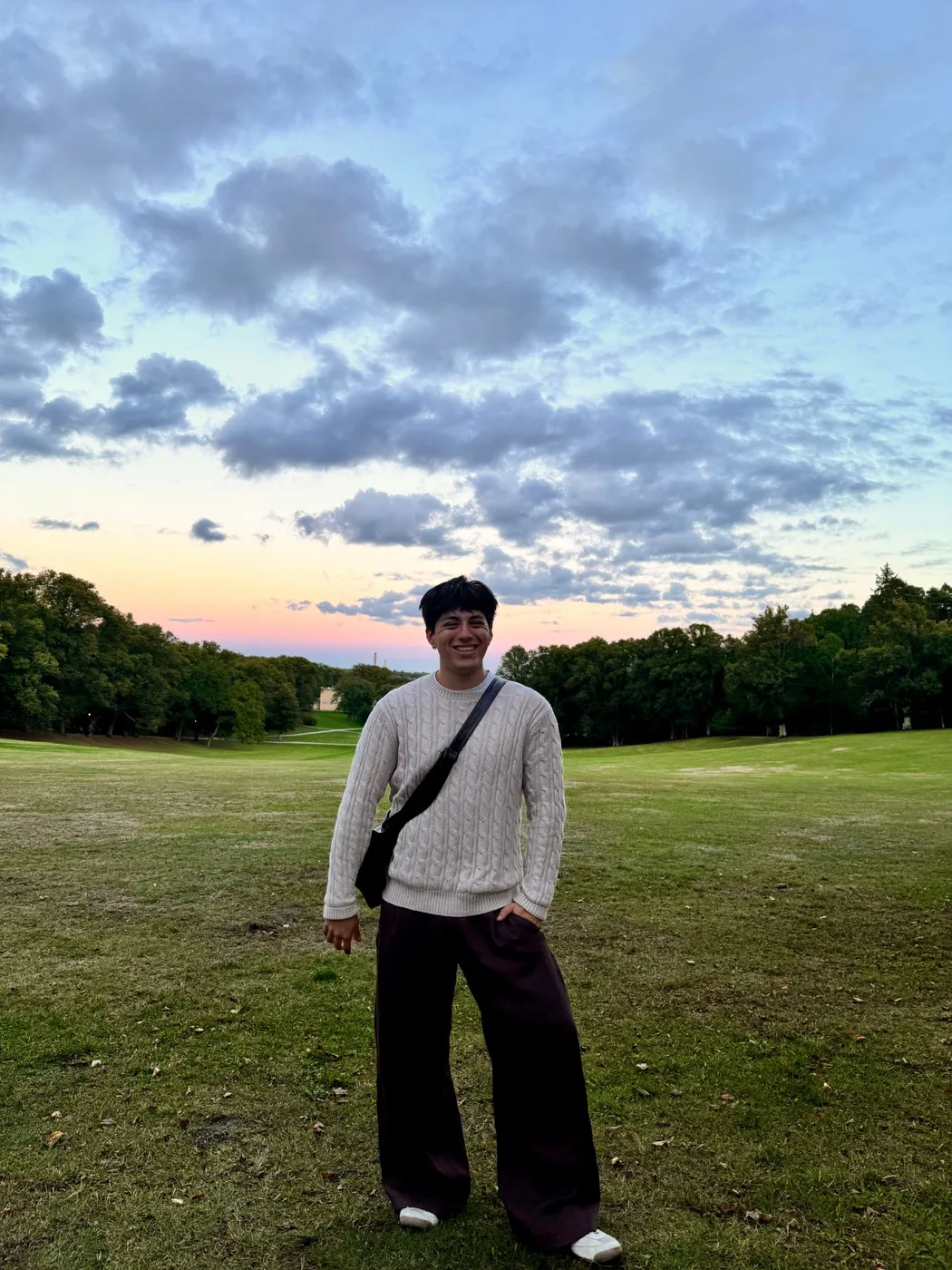 Eric Daniels standing in a park at sunset